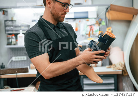 Holding prosthesis. Technician working in modern laboratory 127457137