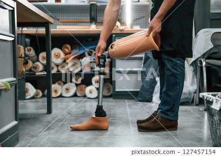 Prosthesis on the floor. Technician working in modern laboratory 127457154