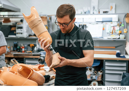 Technician working with prosthesis in modern laboratory 127457209