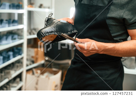With shoe for prosthesis. Technician working in modern laboratory With shoe for prosthesis. Technician working in modern laboratory 127457231