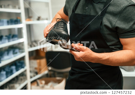 With shoe for prosthesis. Technician working in modern laboratory With shoe for prosthesis. Technician working in modern laboratory 127457232