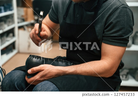 With shoe for prosthesis. Technician working in modern laboratory With shoe for prosthesis. Technician working in modern laboratory 127457233