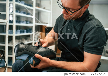With shoe for prosthesis. Technician working in modern laboratory With shoe for prosthesis. Technician working in modern laboratory 127457234