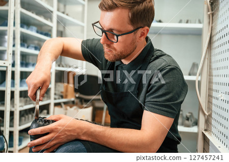 With shoe for prosthesis. Technician working in modern laboratory With shoe for prosthesis. Technician working in modern laboratory 127457241
