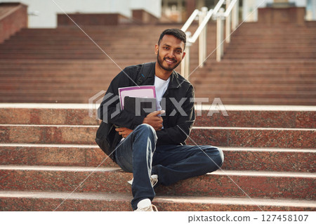 Handsome Indian student is outdoors 127458107