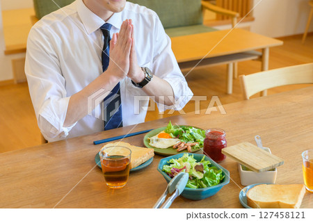 Japanese office worker eating breakfast 127458121