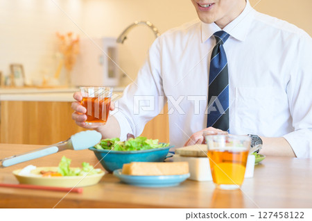 Japanese office worker eating breakfast Japanese office worker eating breakfast 127458122