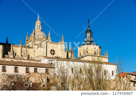 The Segovia Cathedral stands proudly in the skyline, with the Guadarrama mountains visible. The Segovia Cathedral stands proudly in the skyline, with the Guadarrama mountains visible. 127458467