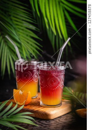 Closeup glass of cocktail with orange juice and red wine Closeup glass of cocktail with orange juice and red wine 127458878