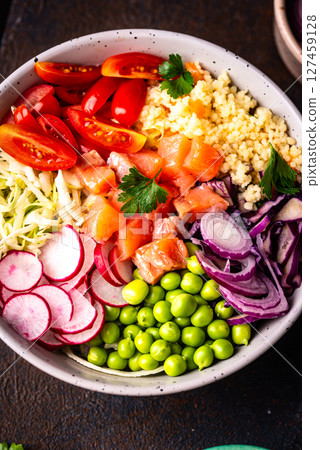 Balanced healthy bowl with vegetables and salmon 127459128