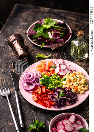 Balanced healthy bowl with vegetables and salmon 127459134