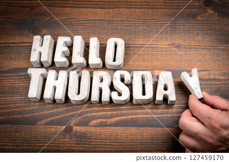 Hello Thursday. Concrete alphabet letters and coffee mug on dark wooden texture background 127459170