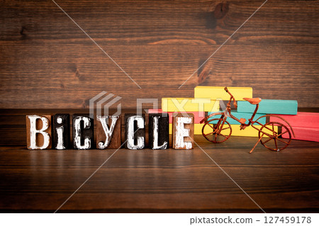 Bicycle Word with Vintage Bike and Colorful Blocks on Wooden Background 127459178
