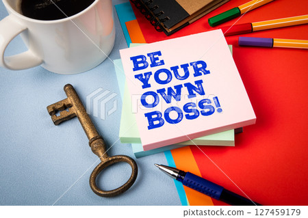 BE YOUR OWN BOSS. Office Supplies, Coffee, and Vintage Key on Colorful Background 127459179