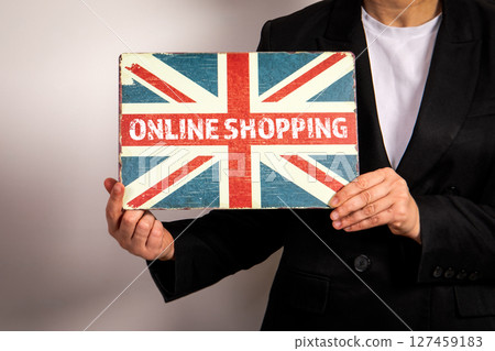 Online Shopping Sign with Union Jack Design Held by Person in Business Suit 127459183