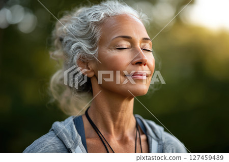 Senior woman doing yoga in a garden 127459489