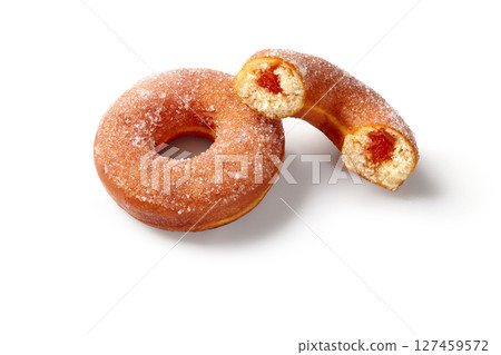Two sugar donuts, one showing jam filling, isolated on white background Two sugar donuts, one showing jam filling, isolated on white background 127459572