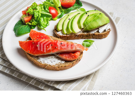 Avocado and salmon open sandwiches 127460363