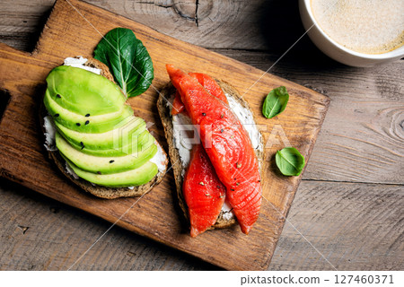 Avocado and salmon open sandwiches 127460371