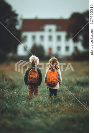 Children Explore a Field Near an Old Mansion on a Cloudy Day in Autumn 127460516