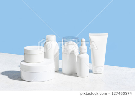 Cosmetic products containers on light blue background 127460574