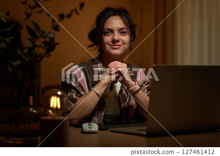 beautiful graphic designer woman working at home office remotely using digital graphic tablet and laptop beautiful graphic designer woman working at home office remotely using digital graphic tablet and laptop 127461412