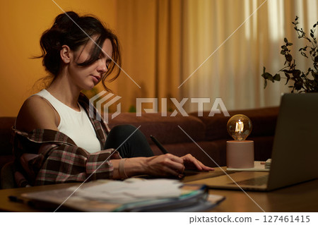 beautiful graphic designer woman working at home office remotely using digital graphic tablet and laptop 127461415