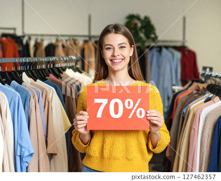 A woman showing a sale flyer A woman showing a sale flyer 127462357