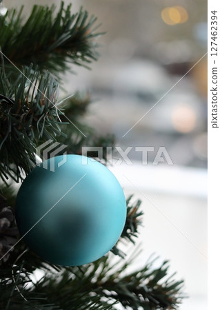 Fir branch with balls and festive lights. 127462394