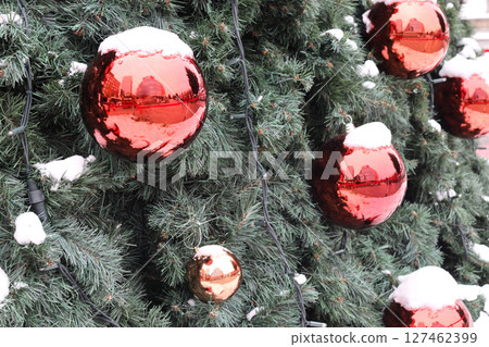 Fir branch with balls and festive lights. 127462399