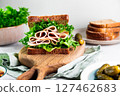 Delicious turkey ham sandwich with fresh green lettuce on whole grain bread, served on a wooden board 127462683