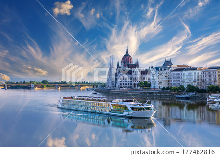 View of cruise ship on the Danube and Budapest Parliament under dramatic sky, Hungary 127462816