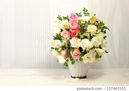 Beautiful still life with flowers of cream tea rose and rose hips on elegant modern table,Abstract flower arrangement. template for your design , minimalist beauty concept, flower card Beautiful still life with flowers of cream tea rose and rose hips on elegant modern table,Abstract flower arrangement. template for your design , minimalist beauty concept, flower card 127463551
