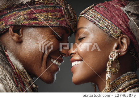 African couple smiling and sharing a joyful moment with traditional attire and accessories 127463879