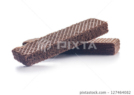 Sweet wafers filled with chocolate cream isolated on white background. 127464082