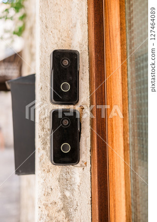 Smart doorbells on old stone entryway. Urban security, smart technology, and modern living in traditional architectural settings. Smart doorbells on old stone entryway. Urban security, smart technology, and modern living in traditional architectural settings. 127464089