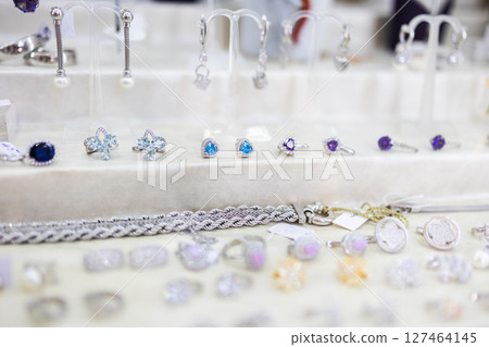 Fine jewelry display with gemstone rings and bracelets. Luxury accessories, fashion elegance, and refined craftsmanship for stylish retail presentation. Fine jewelry display with gemstone rings and bracelets. Luxury accessories, fashion elegance, and refined craftsmanship for stylish retail presentation. 127464145