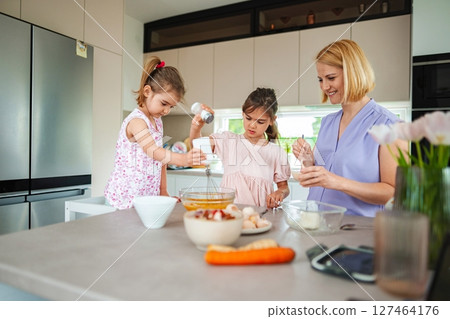 Cooking delights in a bright kitchen with family fun 127464176