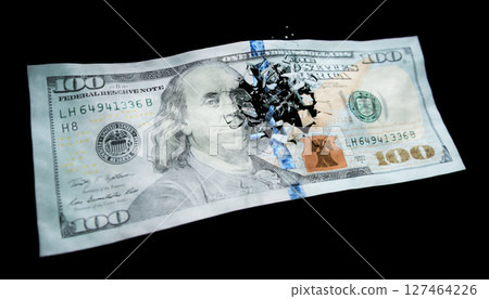 Broken US paper money on a black background 127464226