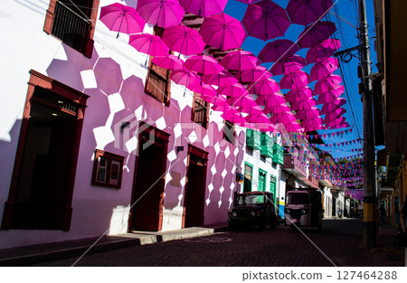 Colorful umbrellas and the beautiful streets of the Heritage Town of Jerico located in the Department of Antioquia in Colombia. 127464288