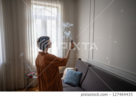 Woman do personal ceremony with smudging stick to refresh enhance mental clarity. Aromatherapy Woman do personal ceremony with smudging stick to refresh enhance mental clarity. Aromatherapy 127464435