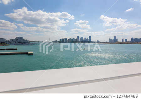 View of city with towers and skyscrapers from Saadiyat Island in Abu Dhabi, United Arab Emirates. View from water surface. High quality photo View of city with towers and skyscrapers from Saadiyat Island in Abu Dhabi, United Arab Emirates. View from water surface. High quality photo 127464469