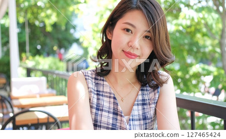 Checkered blouse and white skirt for a summer look 127465424