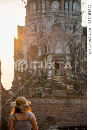 Rear view of young woman walking and exploring Ancient Ruins on holiday travel Rear view of young woman walking and exploring Ancient Ruins on holiday travel 127465602