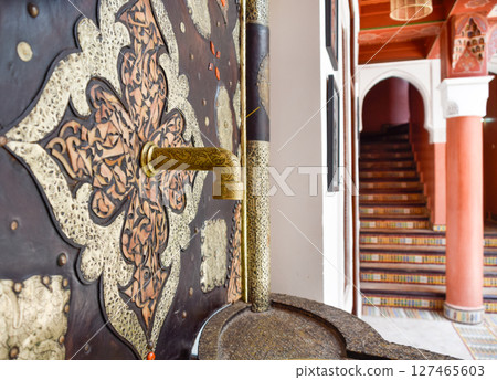 Faucet and fountain with Arabic stairs in background. Typical Marrakech courtyard Faucet and fountain with Arabic stairs in background. Typical Marrakech courtyard 127465603