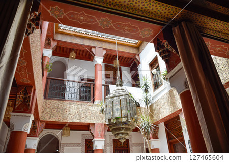 Typical Inner Courtyard Marrakech with red columns and a large colored lamp Typical Inner Courtyard Marrakech with red columns and a large colored lamp 127465604