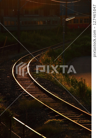 Railroad tracks shining in the afterglow of a summer evening Railroad tracks shining in the afterglow of a summer evening 127465847