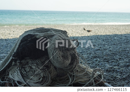 A view of the blue sea and fishing nets piled up A view of the blue sea and fishing nets piled up 127466115