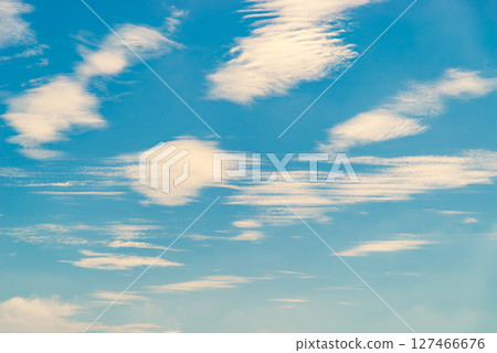 Wave-like clouds scattered in the blue sky h-3 warm color added 127466676