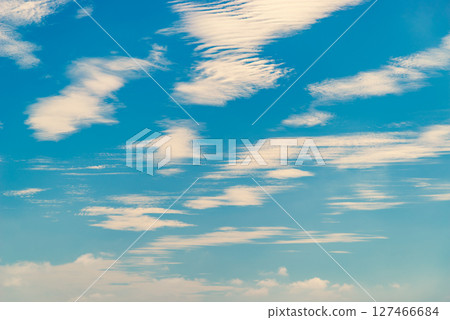 Wave-like clouds scattered in the blue sky j-3 Warm color added 127466684